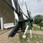 The miller would use this sprocket to rotate the head of windmill to face it into the wind. The chains would hold it in place.
